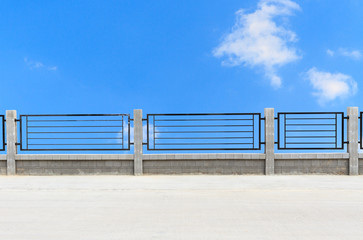 Fototapeta premium metal fences on cement road with clouds
