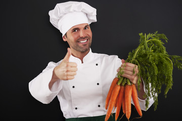 Chef with bunch of carrots showing thumbs up
