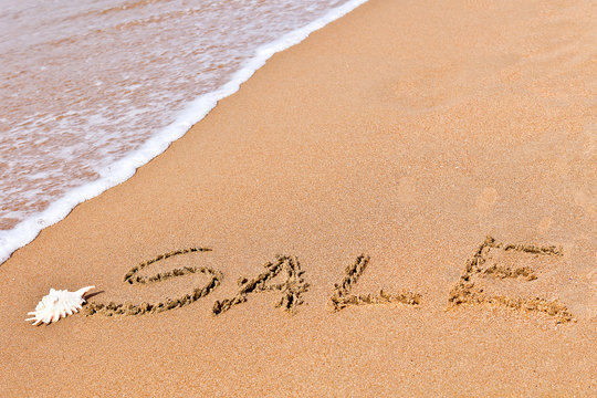 written sale drawn on the sand