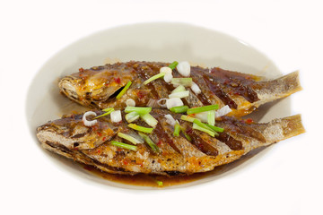 Fried fish on plate, isolated on white background