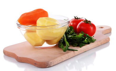 Peeled vegetables in bowl isolated on white