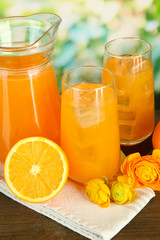 Glasses and pitcher of orange juice
