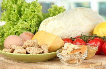 Ingredients for Caesar salad on bright background