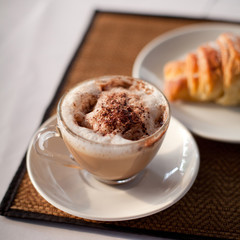 breakfast, coffee and croissant on the table.