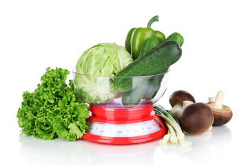 Fresh vegetables in scales isolated on white