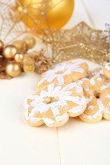 Christmas cookies and decorations on color wooden background