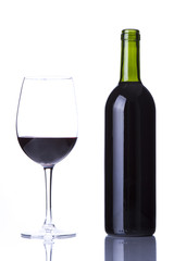 Glass with red wine and bottle of red wine