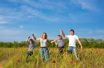 Family playing on the meadow