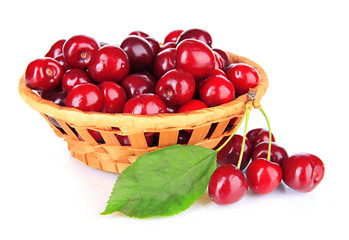 Cherry berries in wicker basket isolated on white