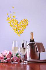 Champagne and glasses on round table on room  background