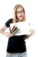 Happy young girl with  colored pencils  and empty white paper