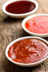 various barbecue sauces in ceramic bowls