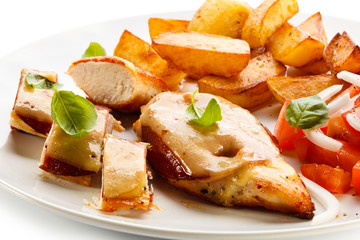 Grilled chicken breasts with cheese and baked potatoes
