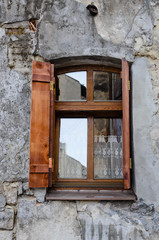 Wooden window on an old degraded wall