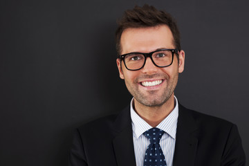 Portrait of handsome businessman wearing glasses .