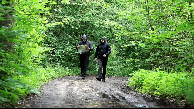 Hikers with map and binoculars on forest trails episode 2