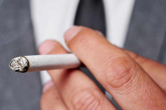 man in suit smoking