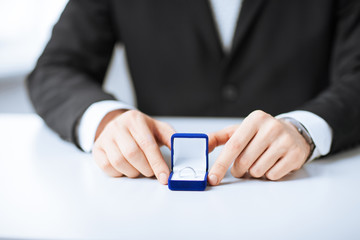 man with gift box and wedding ring