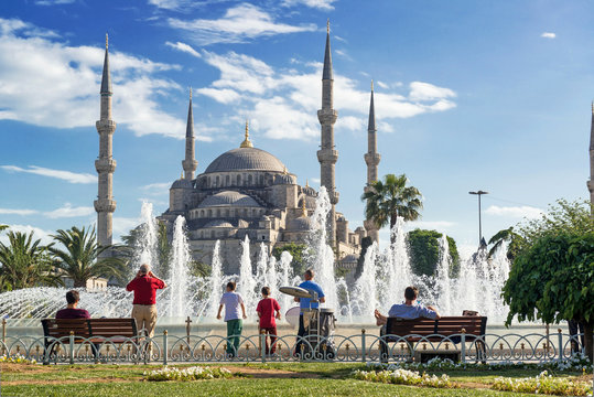 Tourists admiring nice fountain and Blue Mosque, Istanbul, Turkey