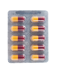 Yellow and brown capsule in transparent blister pack