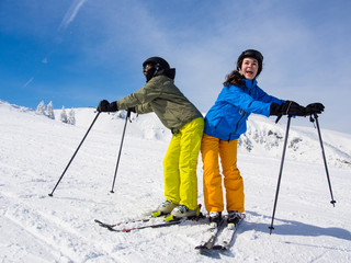 Teenage girl and boy skiing