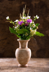 Beautiful bouquet of bright wildflowers in vase