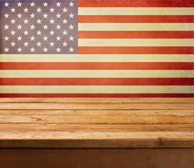 Fototapeta premium Empty wooden deck table over USA flag background