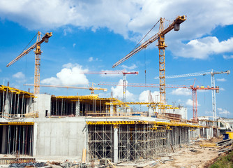 building construction and cranes over blue sky