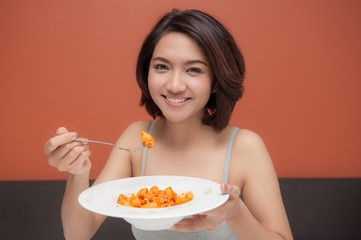 asian young woman eat spaghetti pasta tomatoes sauce