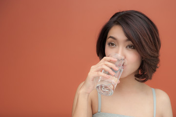 young woman drinking water with text space