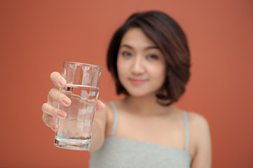 healthy young woman holding  with glass of drinking water