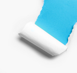 corner white torn paper with blue background