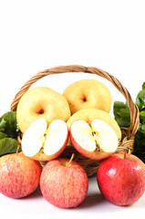 Apple and Asiatic in basket on white background