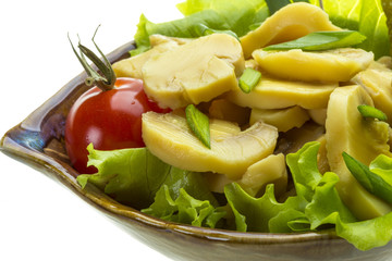 Marinated mushrooms in white saucer isolated on white