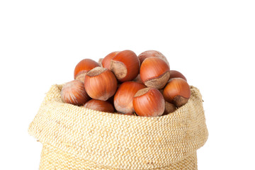 fresh hazelnuts in a bag on white background