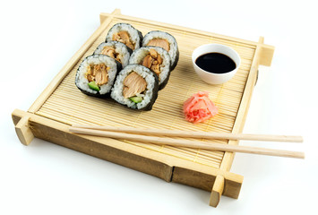 Teriyaki chicken sushi on bamboo tray with soy sauce and ginger © Enlightened Media
