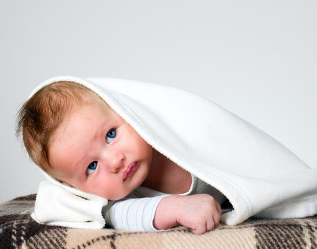 Baby Boy Holds Raised Head With Blanket Over Head
