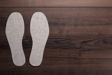 insoles for shoes on wooden background
