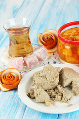 Tasty halva with tea on table