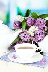 Composition with beautiful lilac flowers, tea service