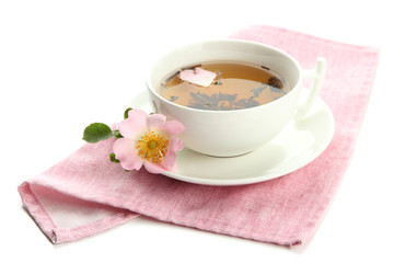 Cup of herbal tea with hip rose flowers, isolated on white