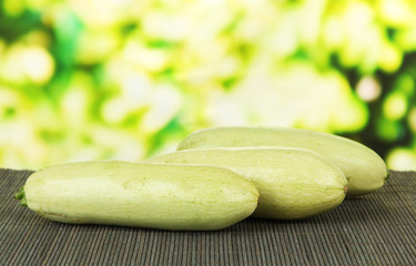 Fresh marrows on bamboo mat, on bright background