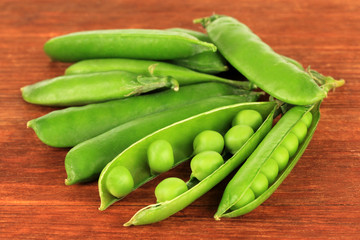 Sweet green peas on wooden background