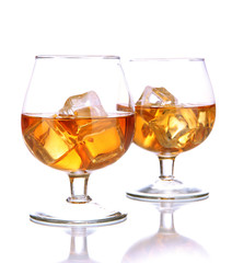 Brandy glasses with ice isolated on white