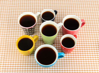 Many cups of coffee on checkered napkin