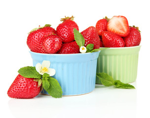 Ripe sweet strawberries in bowls, isolated on white