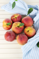 Peaches on napkin on wooden table