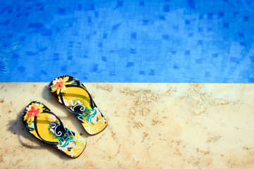 woman flip-flops near clear pool