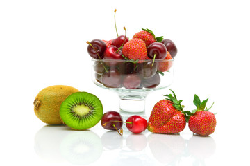 berries and fruits. kiwi, strawberry and cherry on a white backg