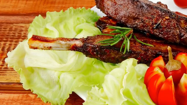 served ribs with cutlery on wooden table 1920x1080 intro motion 